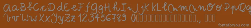 Tanaestelbrushscript01Regular-fontti – harmaat kirjasimet ruskealla taustalla