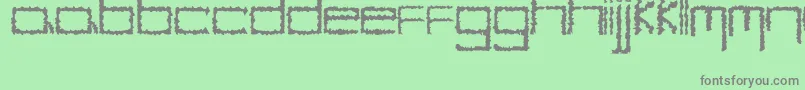 YbHybrid-fontti – harmaat kirjasimet vihreällä taustalla