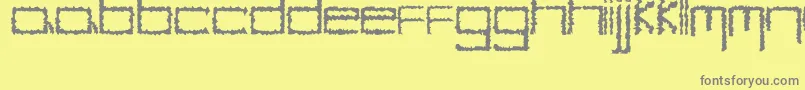 YbHybrid-fontti – harmaat kirjasimet keltaisella taustalla