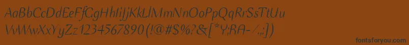 フォントEllipseItcTtItalic – 黒い文字が茶色の背景にあります