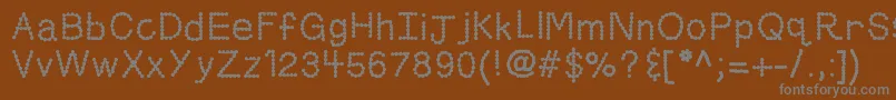 Fonte Kbskittledup – fontes cinzas em um fundo marrom