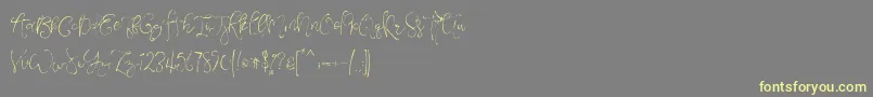 フォントVeronaLotteScript – 黄色のフォント、灰色の背景