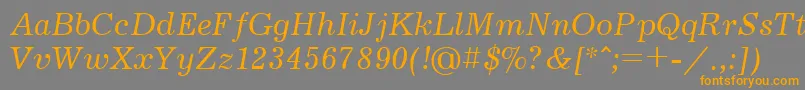 フォントJournalcttItalic – オレンジの文字は灰色の背景にあります。