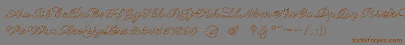フォントCantateBeveled – 茶色の文字が灰色の背景にあります。