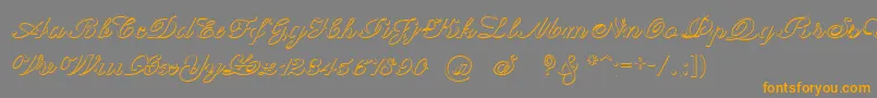 フォントCantateBeveled – オレンジの文字は灰色の背景にあります。