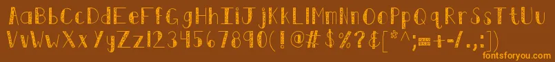フォントKbswirlntwirl – オレンジ色の文字が茶色の背景にあります。