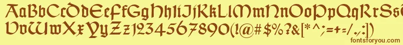 フォントTypographerUncialgotisch – 茶色の文字が黄色の背景にあります。