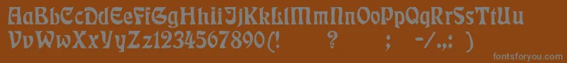Badmann-fontti – harmaat kirjasimet ruskealla taustalla