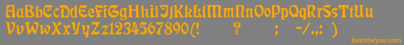 フォントBadmann – オレンジの文字は灰色の背景にあります。