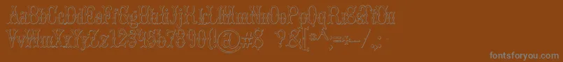 BrucedoublepicaBeveled-Schriftart – Graue Schriften auf braunem Hintergrund