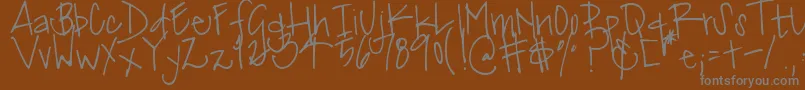 DjbMissJinkieVanPelt-fontti – harmaat kirjasimet ruskealla taustalla
