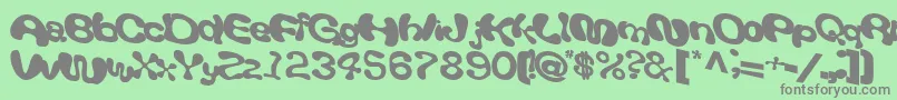 Giveandtake18Bold-fontti – harmaat kirjasimet vihreällä taustalla