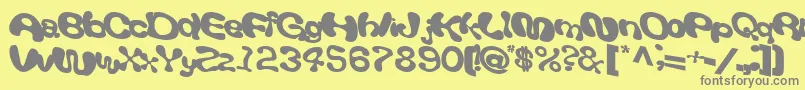 Giveandtake18Bold-fontti – harmaat kirjasimet keltaisella taustalla