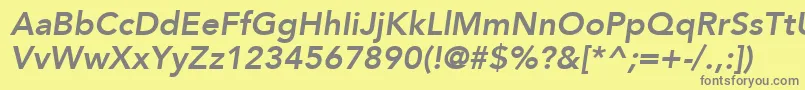 AvenirLt86HeavyOblique-fontti – harmaat kirjasimet keltaisella taustalla