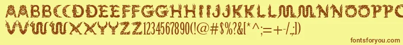 フォントMythos – 茶色の文字が黄色の背景にあります。