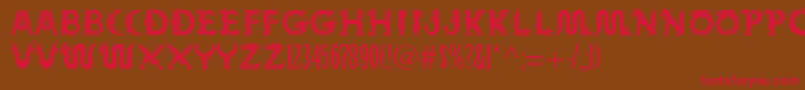 フォントMythos – 赤い文字が茶色の背景にあります。