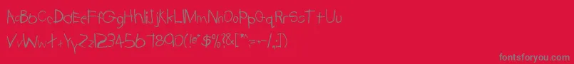 TrionaaRegular-Schriftart – Graue Schriften auf rotem Hintergrund