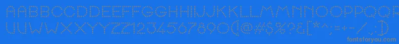 K22SpottyFace-Schriftart – Graue Schriften auf blauem Hintergrund