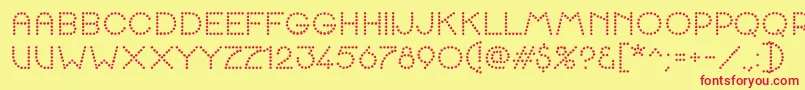 K22SpottyFace-fontti – punaiset fontit keltaisella taustalla