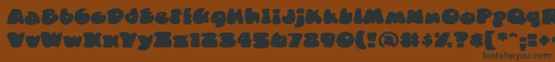 DuncecapbbReg Font – Black Fonts on Brown Background