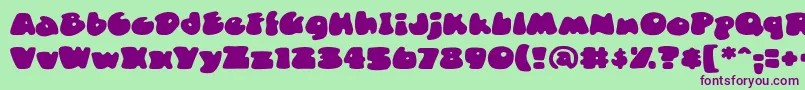DuncecapbbReg-fontti – violetit fontit vihreällä taustalla