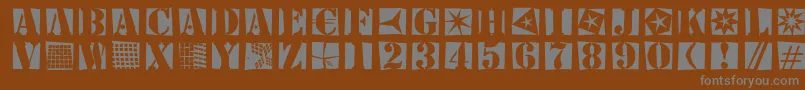 Stencilbricksrandom-fontti – harmaat kirjasimet ruskealla taustalla