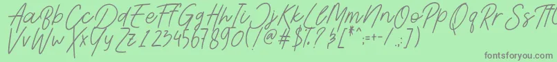 AesthetikScriptDemo-fontti – harmaat kirjasimet vihreällä taustalla