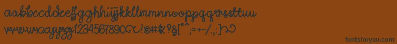 Weitere Informationen zur LightheartScriptRegular-Schriftart LightheartScriptRegular-Schriftart – Schwarze Schriften auf braunem Hintergrund