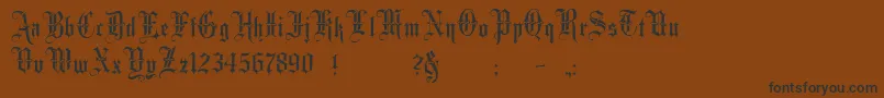 フォントMinsterNo3 – 黒い文字が茶色の背景にあります