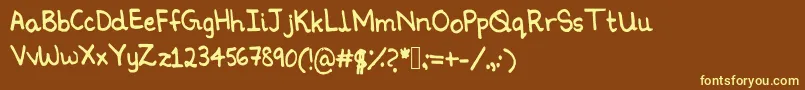 Ninoshandwriting-fontti – keltaiset fontit ruskealla taustalla