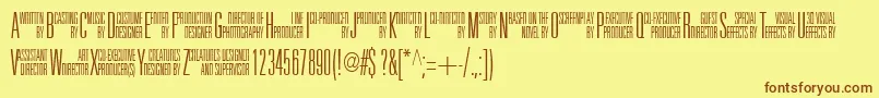 フォントUniAcc – 茶色の文字が黄色の背景にあります。