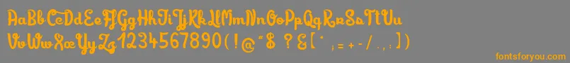 フォントLimonadedecamomille – オレンジの文字は灰色の背景にあります。