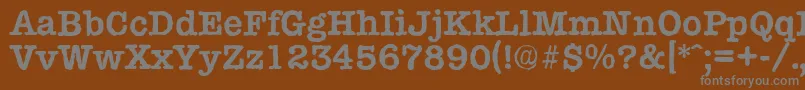 TypewriterantiqueBold-fontti – harmaat kirjasimet ruskealla taustalla