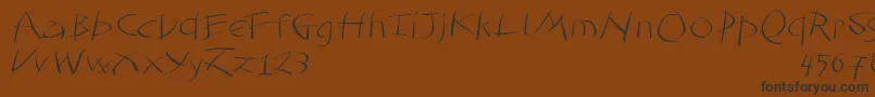 フォントTomahawked – 黒い文字が茶色の背景にあります