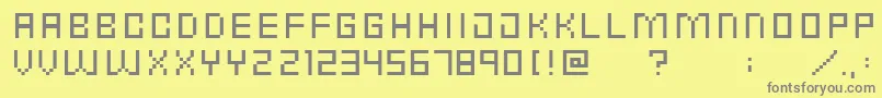 PunkRockFontCondensedThin-fontti – harmaat kirjasimet keltaisella taustalla