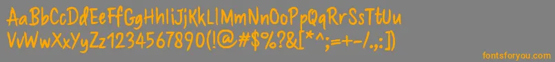 フォントBrushaff – オレンジの文字は灰色の背景にあります。