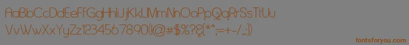 フォントAsenine – 茶色の文字が灰色の背景にあります。