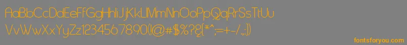 フォントAsenine – オレンジの文字は灰色の背景にあります。