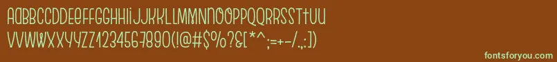 フォントEscalopeSoft – 緑色の文字が茶色の背景にあります。