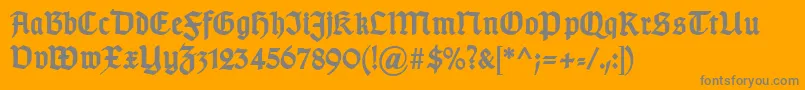 TypographergotischDBold-Schriftart – Graue Schriften auf orangefarbenem Hintergrund