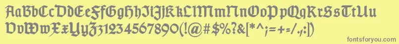 TypographergotischDBold-Schriftart – Graue Schriften auf gelbem Hintergrund