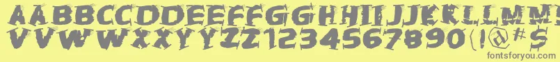 フォントThetrampstrash – 黄色の背景に灰色の文字