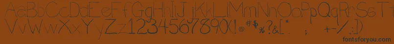 フォントPenmanship.B – 黒い文字が茶色の背景にあります