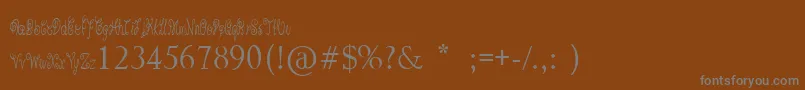PixieMoon-fontti – harmaat kirjasimet ruskealla taustalla