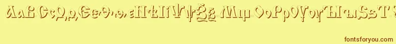 フォントIzhitsashadowcttRegular – 茶色の文字が黄色の背景にあります。