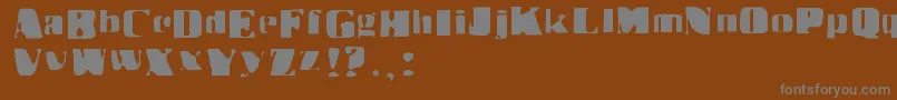 Drbenway-fontti – harmaat kirjasimet ruskealla taustalla