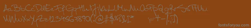 Fonte AspadesRegular – fontes cinzas em um fundo marrom