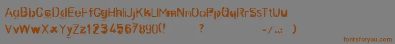 フォントZombnze – 茶色の文字が灰色の背景にあります。
