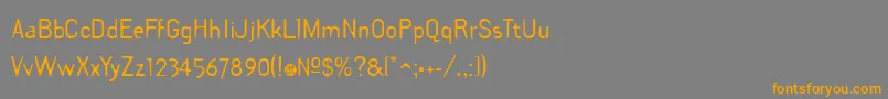 フォントDraftPlate – オレンジの文字は灰色の背景にあります。