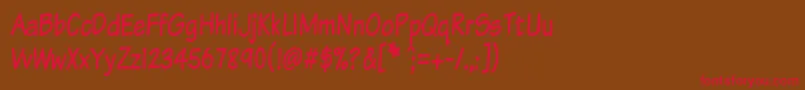 フォントKomtxtt – 赤い文字が茶色の背景にあります。